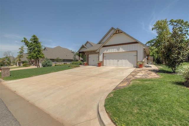 craftsman inspired home featuring a garage, driveway, a front lawn, and brick siding