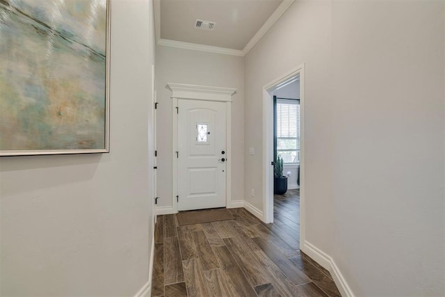entrance foyer featuring baseboards, ornamental molding, dark wood-style flooring, and visible vents