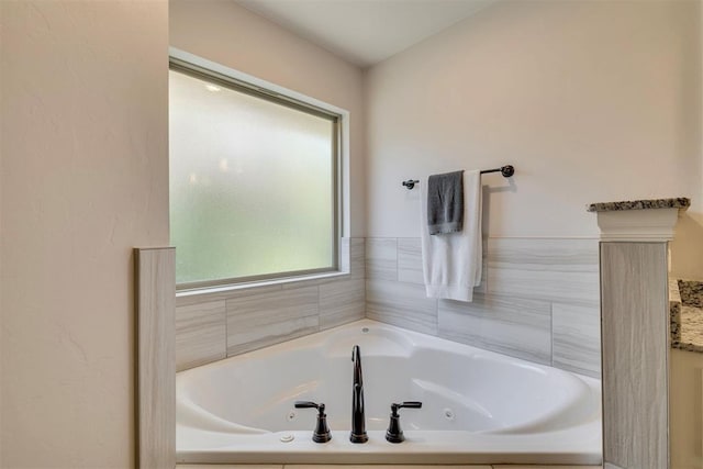 full bathroom featuring a tub with jets