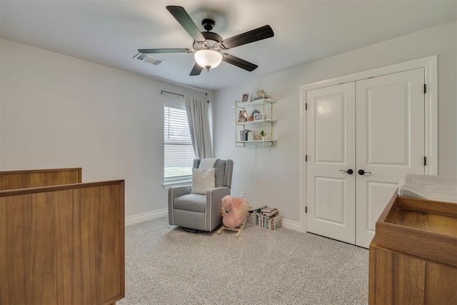 living area featuring visible vents, baseboards, ceiling fan, and carpet floors