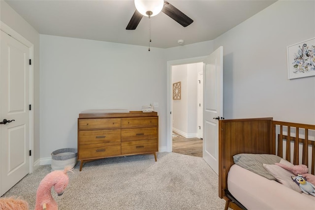 bedroom with baseboards, light carpet, and ceiling fan