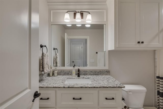 bathroom with toilet and vanity