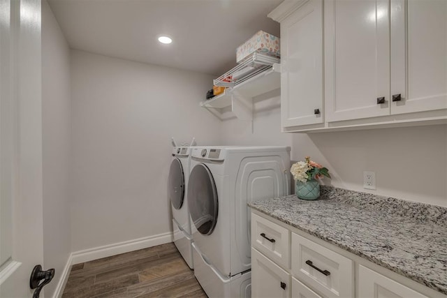 laundry room with dark wood-style flooring, independent washer and dryer, cabinet space, baseboards, and recessed lighting