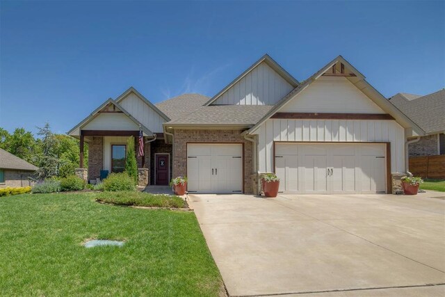 8817 Arya Rd, Arcadia, OK 73007 - view of front facade featuring an attached garage, a front lawn, concrete driveway, roof with shingles, and brick siding