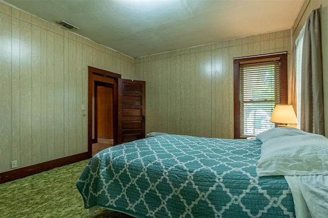 801 Lincoln St, Ryan, OK 73565 - bedroom featuring carpet and wood walls