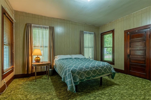 801 Lincoln St, Ryan, OK 73565 - carpeted bedroom with wood walls