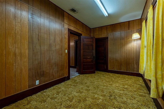 801 Lincoln St, Ryan, OK 73565 - unfurnished room featuring wood walls and carpet flooring