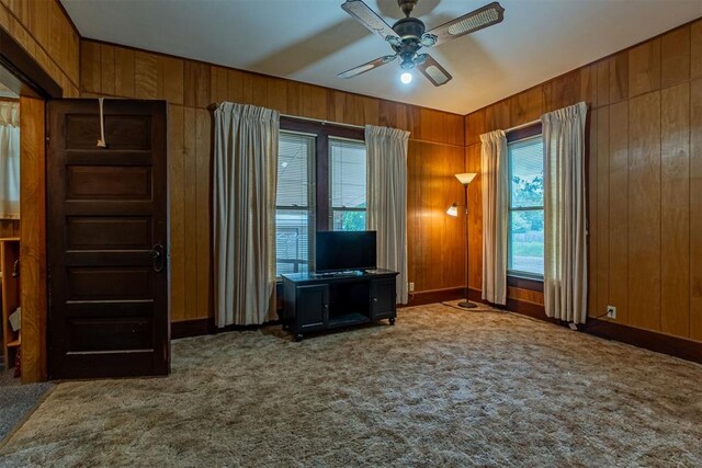801 Lincoln St, Ryan, OK 73565 - unfurnished office with carpet floors, wooden walls, a ceiling fan, and baseboards