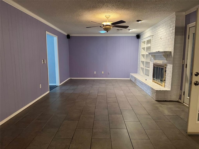 unfurnished living room with a textured ceiling, crown molding, baseboards, a fireplace, and a ceiling fan