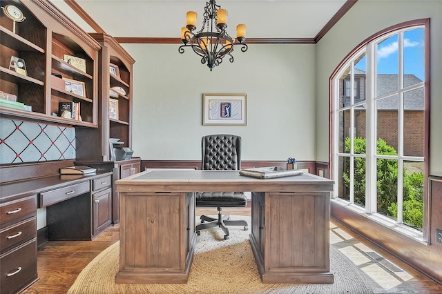 office area with crown molding, plenty of natural light, wood finished floors, and a notable chandelier