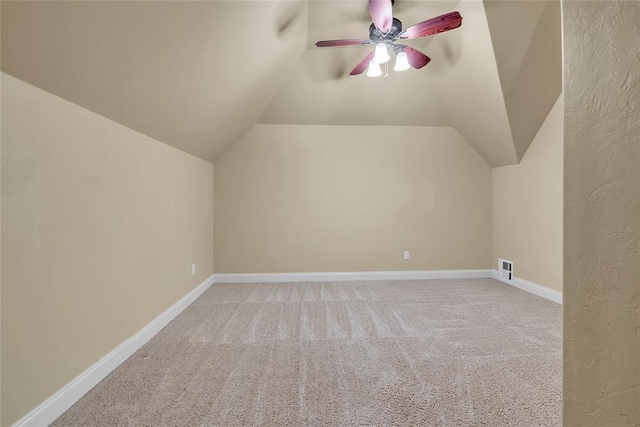 bonus room with ceiling fan, vaulted ceiling, baseboards, and carpet