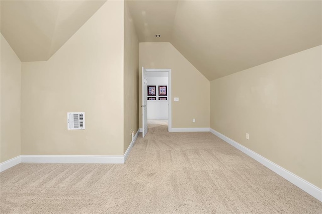 bonus room with baseboards, vaulted ceiling, light carpet, and visible vents