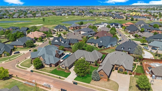 bird's eye view featuring a water view, view of golf course, and a residential view
