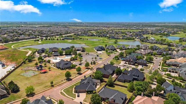 drone / aerial view with a residential view and a water view