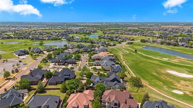 birds eye view of property featuring a water view, a residential view, and golf course view