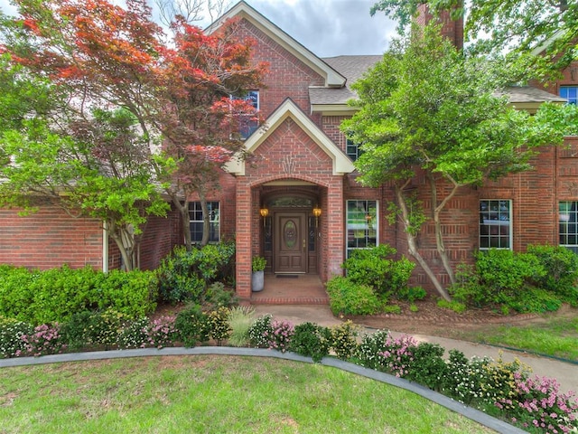 3601 Rena Dawn Ln, Edmond, OK 73013 - traditional-style home featuring brick siding, a chimney, and roof with shingles