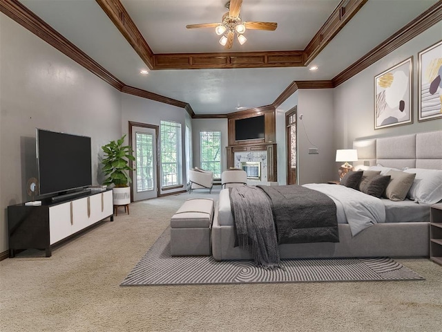 3601 Rena Dawn Ln, Edmond, OK 73013 - carpeted bedroom with a glass covered fireplace, a raised ceiling, crown molding, and recessed lighting