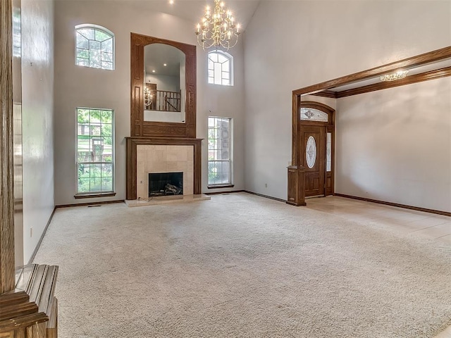 3601 Rena Dawn Ln, Edmond, OK 73013 - unfurnished living room with a notable chandelier, a high ceiling, light colored carpet, and plenty of natural light