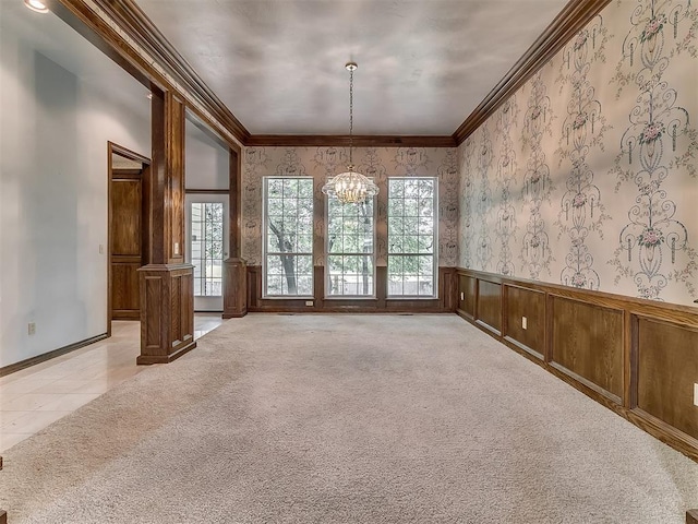 3601 Rena Dawn Ln, Edmond, OK 73013 - empty room with light carpet, a chandelier, a wainscoted wall, wallpapered walls, and ornamental molding