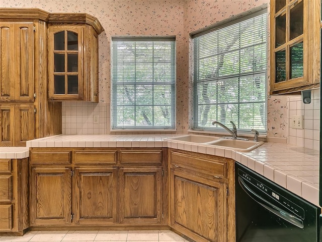 3601 Rena Dawn Ln, Edmond, OK 73013 - kitchen featuring decorative backsplash, glass insert cabinets, wallpapered walls, a sink, and dishwasher