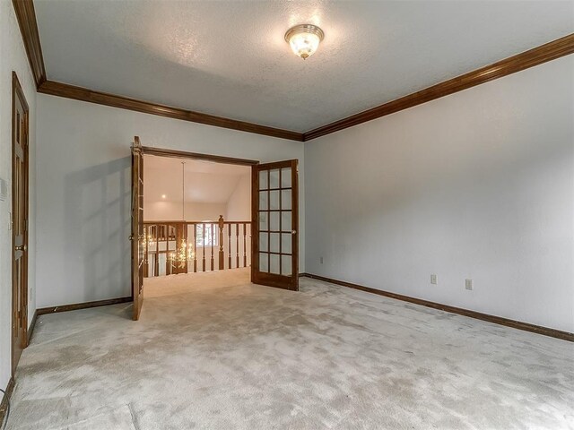 3601 Rena Dawn Ln, Edmond, OK 73013 - carpeted spare room featuring crown molding, a textured ceiling, and baseboards