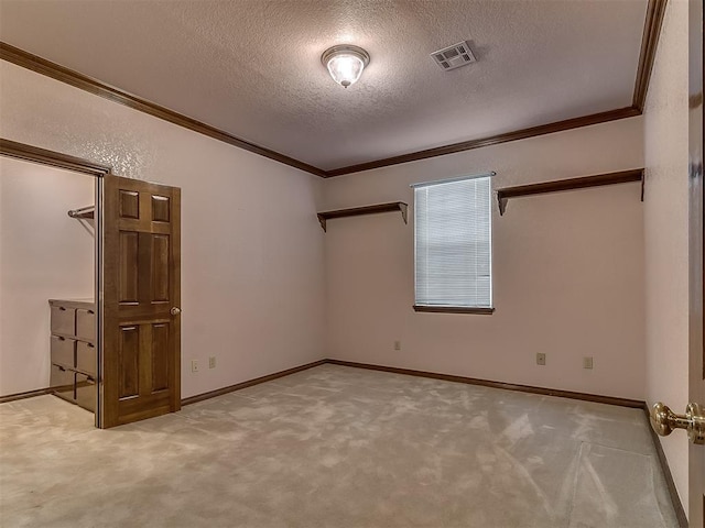 3601 Rena Dawn Ln, Edmond, OK 73013 - carpeted empty room featuring crown molding, a textured ceiling, visible vents, and baseboards
