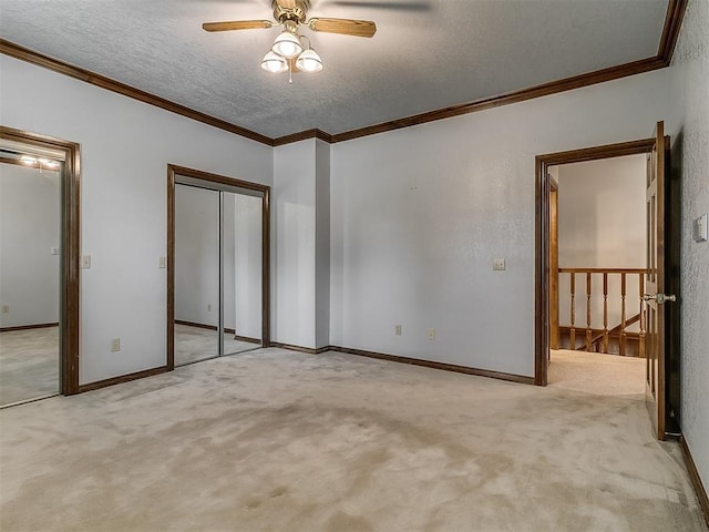 3601 Rena Dawn Ln, Edmond, OK 73013 - unfurnished bedroom featuring crown molding, carpet floors, a textured ceiling, baseboards, and a closet