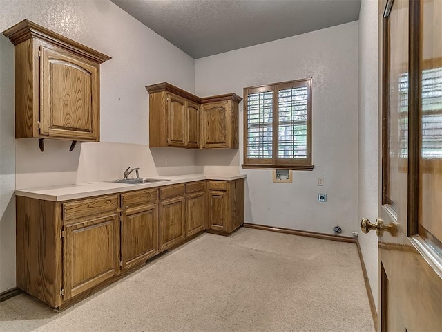 3601 Rena Dawn Ln, Edmond, OK 73013 - clothes washing area featuring electric dryer hookup, cabinet space, a sink, hookup for a washing machine, and light carpet