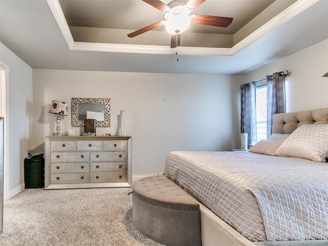 carpeted bedroom with a raised ceiling, baseboards, and a ceiling fan