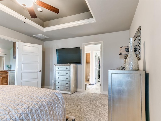 carpeted bedroom with a raised ceiling, baseboards, and visible vents