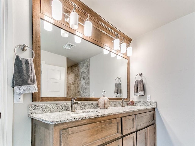full bathroom with visible vents, a sink, and double vanity
