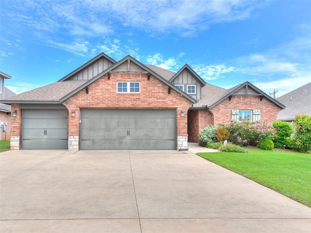 craftsman-style home with board and batten siding, an attached garage, driveway, and a front lawn