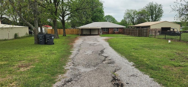 exterior space with a front yard, aphalt driveway, and fence