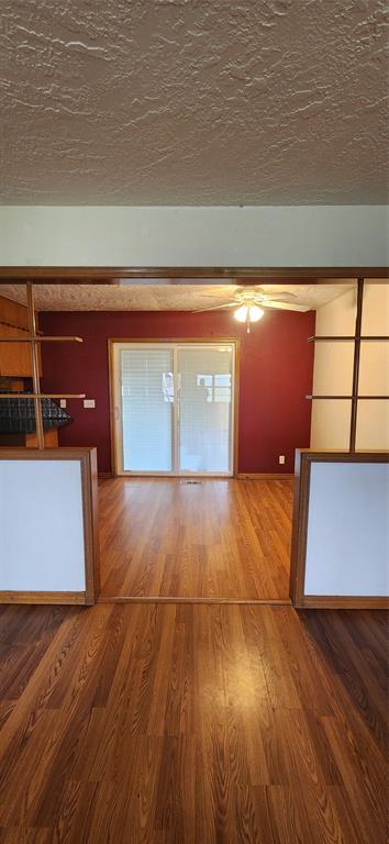 interior space with wood finished floors and ceiling fan