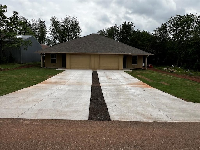 ranch-style home featuring a garage, a front yard, and driveway