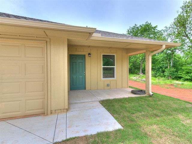 1823 E Rutgers Ave, Guthrie, OK 73044 - doorway to property featuring board and batten siding, roof with shingles, a yard, and driveway