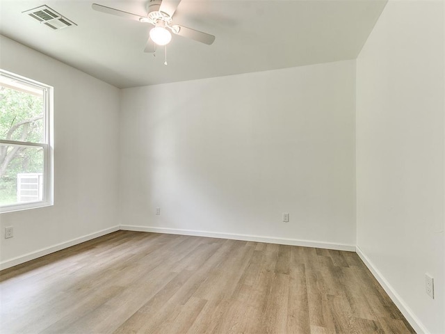 1823 E Rutgers Ave, Guthrie, OK 73044 - unfurnished room with visible vents, a ceiling fan, light wood-style flooring, and baseboards