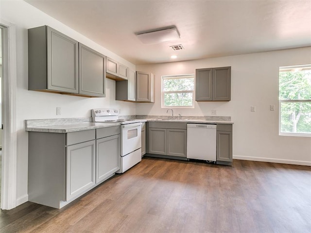 1823 E Rutgers Ave, Guthrie, OK 73044 - kitchen with visible vents, gray cabinetry, a sink, and white appliances