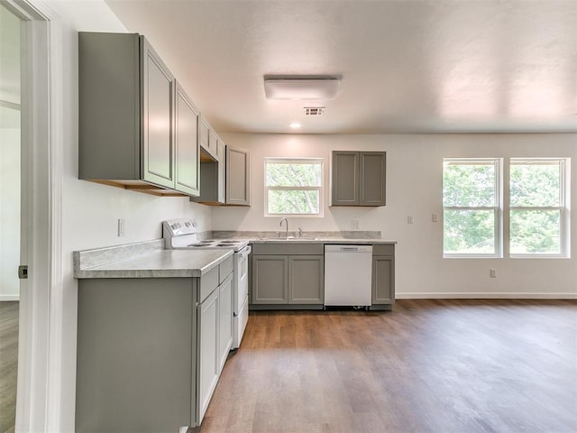 1823 E Rutgers Ave, Guthrie, OK 73044 - kitchen featuring gray cabinets, visible vents, wood finished floors, baseboards, and white appliances