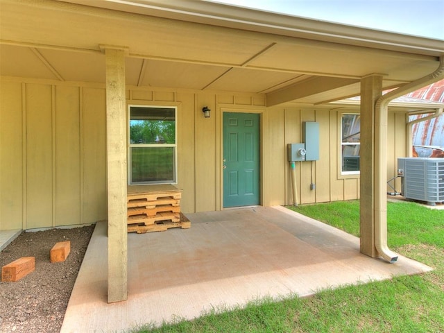 1823 E Rutgers Ave, Guthrie, OK 73044 - entrance to property featuring board and batten siding and cooling unit