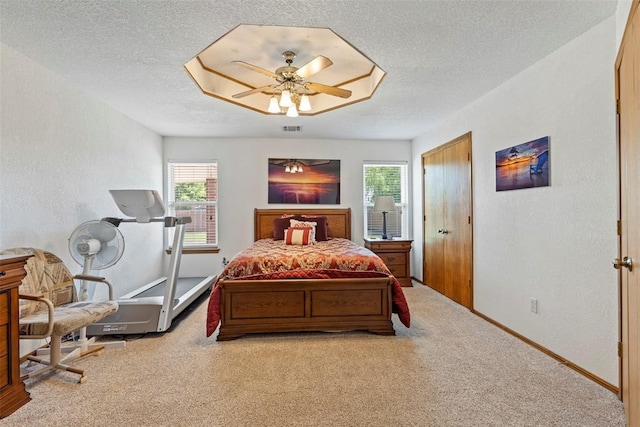 bedroom with carpet floors, visible vents, and multiple windows