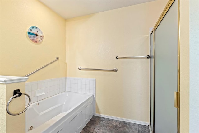 bathroom with baseboards and a bath
