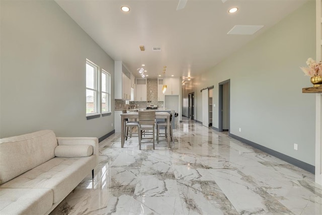 living room with recessed lighting, marble finish floor, visible vents, and baseboards