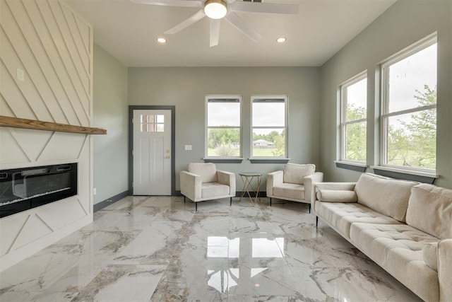 living area featuring recessed lighting, a large fireplace, marble finish floor, baseboards, and a ceiling fan