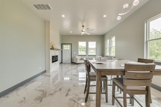 dining room featuring baseboards, visible vents, a fireplace, and recessed lighting