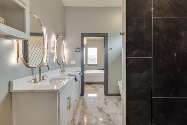bathroom featuring vanity, ensuite bath, and marble finish floor