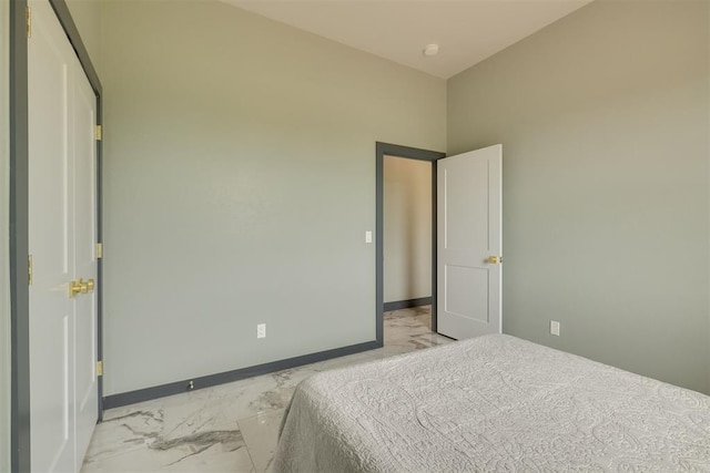 bedroom featuring baseboards and marble finish floor