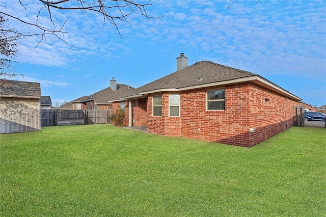 2405 Chadsford Ln, Yukon, OK 73099 - back of property featuring brick siding, roof with shingles, and a chimney