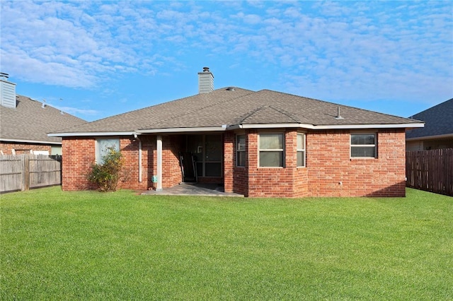 2405 Chadsford Ln, Yukon, OK 73099 - back of property with brick siding, a chimney, a patio, and roof with shingles