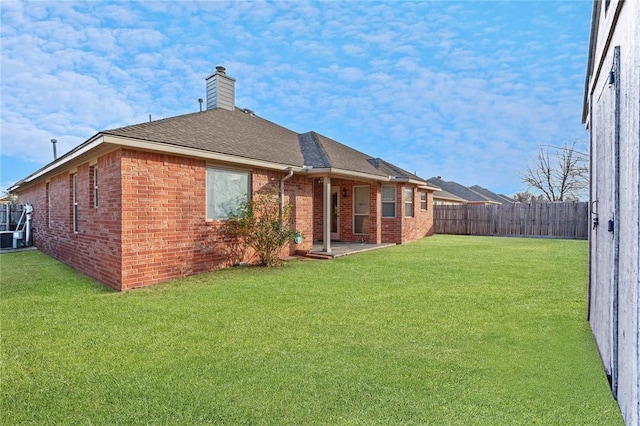 2405 Chadsford Ln, Yukon, OK 73099 - back of property with brick siding, a chimney, a patio, roof with shingles, and central air condition unit